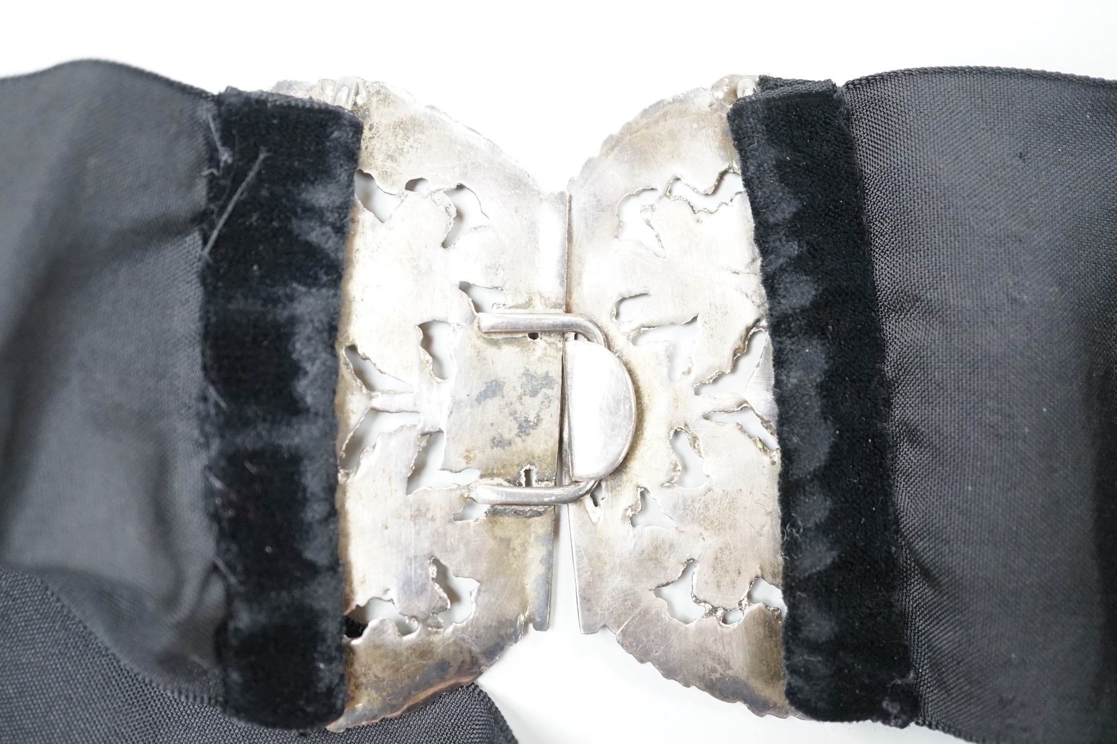 A late Victorian pierced silver belt buckle, on a black sash belt, James Deakin & Sons, Chester, 1895 (a.f.), buckle 13cm.